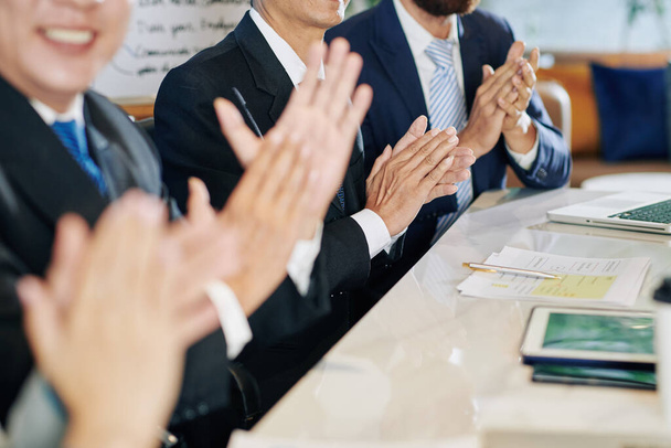 Group of smiling business people clapping to speaker at meeting - Photo, Image
