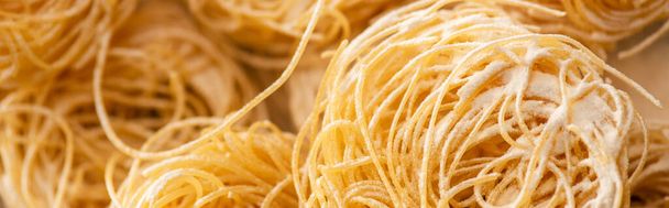 close up view of raw Italian Capellini with flour, panoramic shot - Zdjęcie, obraz