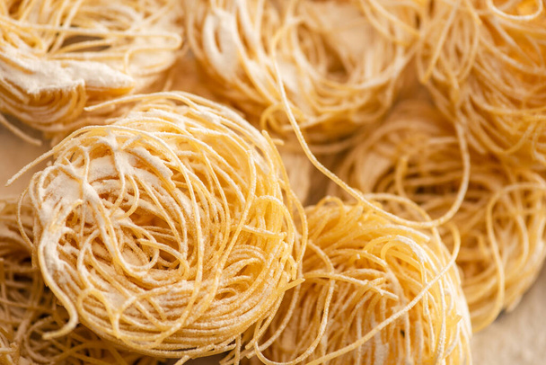 close up view of raw Italian Capellini with flour - Фото, изображение