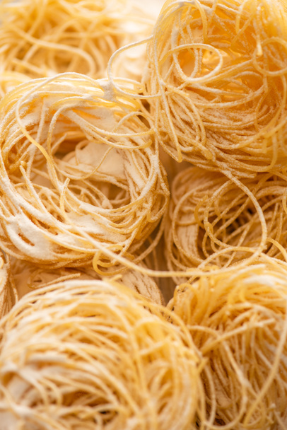close up view of raw Italian Capellini with flour - 写真・画像