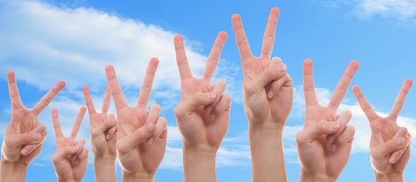 Young people showing the peace sign - Photo, Image