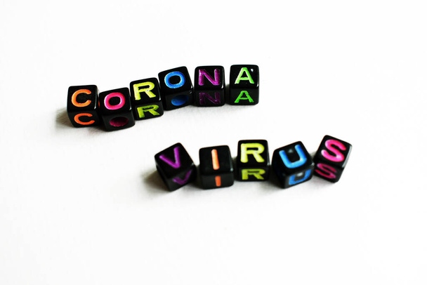 "Coronavirus háttere. Word Coronavirus fekete blokkok, kockák fehér háttér, szivárvány színű kockák - Fotó, kép