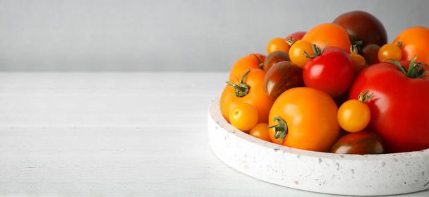 Fresh cherry tomatoes on white table, space for text. Banner design  - Photo, Image