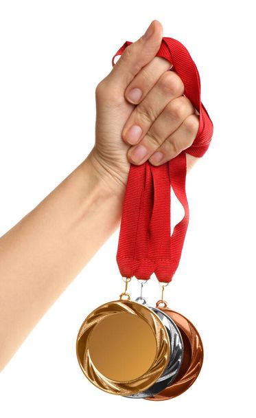 Woman holding medals on white background, closeup. Space for design - Foto, Bild