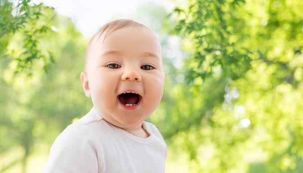 portrait of happy laughing little baby over nature - Foto, immagini