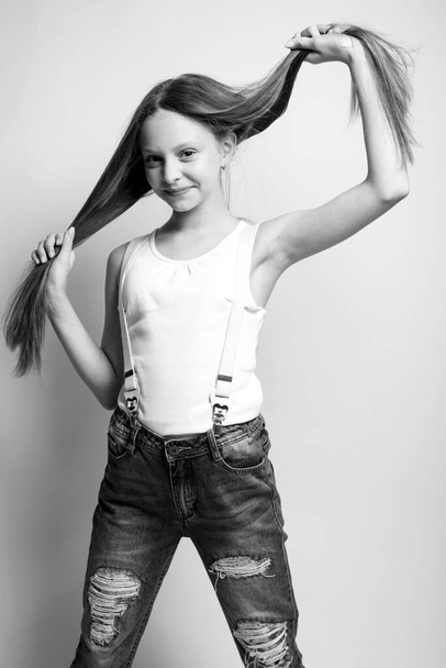 Beautiful child. Little girl in black and white studio.  - Fotografie, Obrázek
