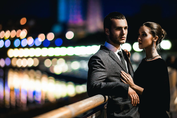 attractive couple in stylish outfit hugging outside at night  - Foto, Imagem