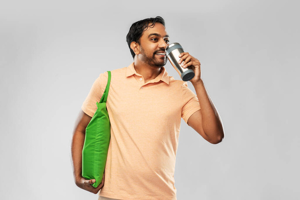 man with food in bag and tumbler or thermo cup - Foto, Imagem