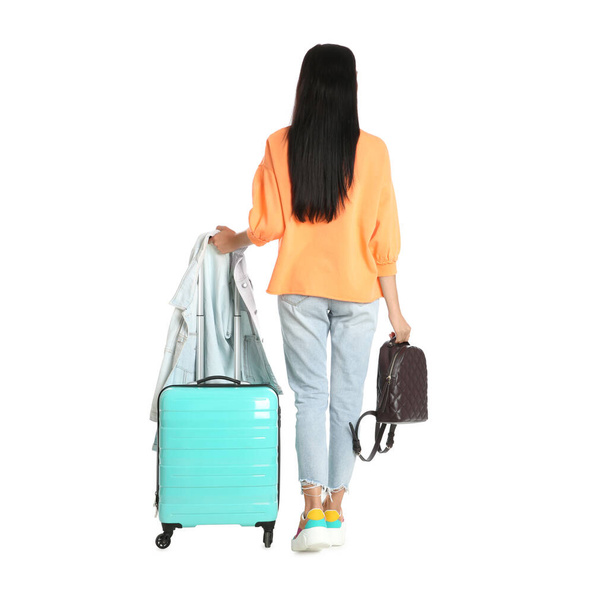 Beautiful woman with suitcase and backpack for summer trip on white background, back view. Vacation travel - Foto, Bild