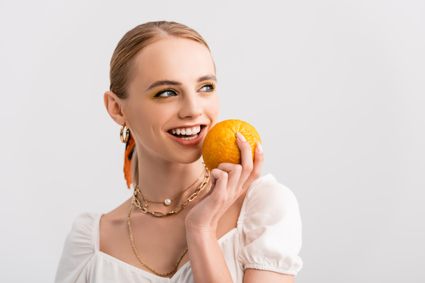 blonde woman posing with orange isolated on white - Фото, зображення