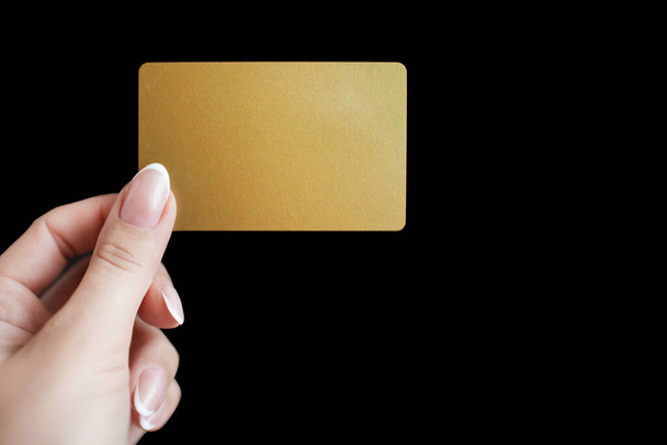 woman hand holding credit card on dark background - 写真・画像