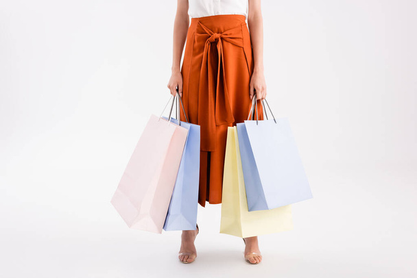 cropped view of elegant woman with shopping bags on white - Zdjęcie, obraz