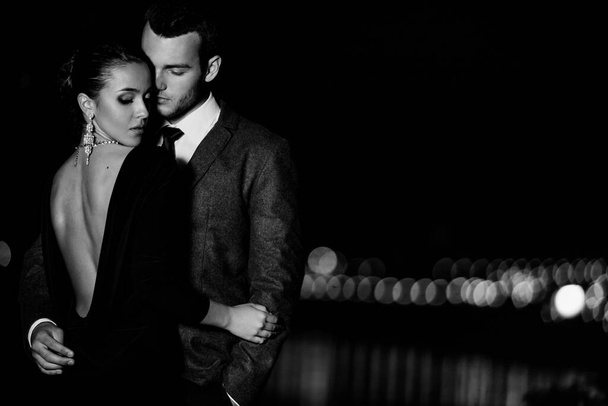 tender couple in stylish outfit hugging outside at evening - Photo, Image