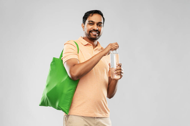 man with bag for food shopping and glass bottle - Foto, imagen