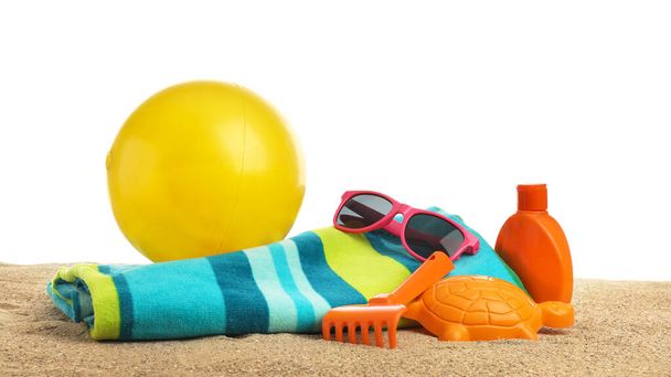 Set of beach accessories for children on sand against white background - Foto, Imagem