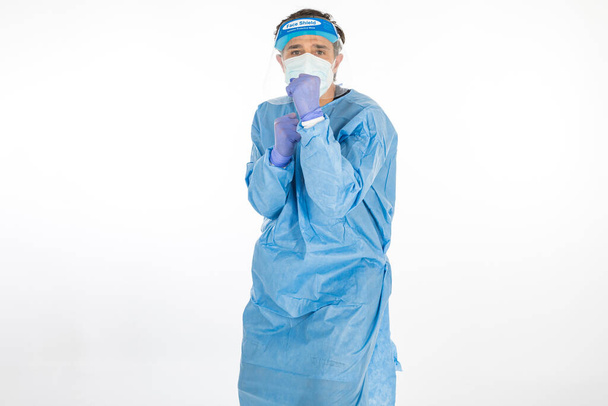 Doctor wearing blue PPE to fight coronavirus, prepared to fight, on white background. Warrior. COVID medicine concept - Photo, Image