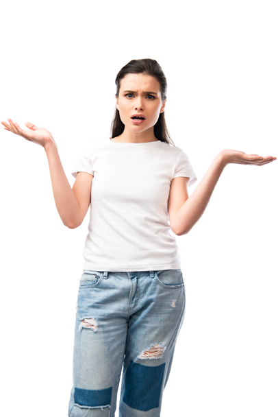 displeased young woman in white t-shirt gesturing and looking at camera isolated on white  - Photo, Image