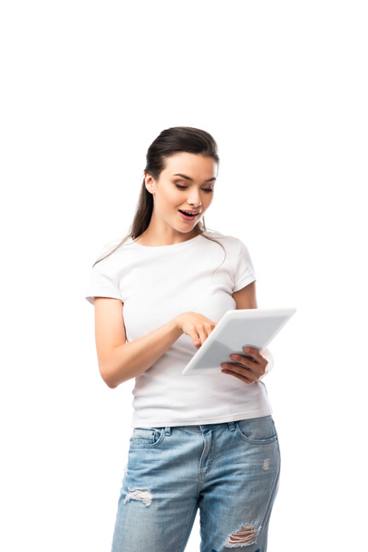 brunette woman in white t-shirt using digital tablet isolated on white  - Фото, изображение