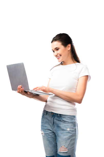 brunette woman in white t-shirt using laptop isolated on white  - Fotó, kép