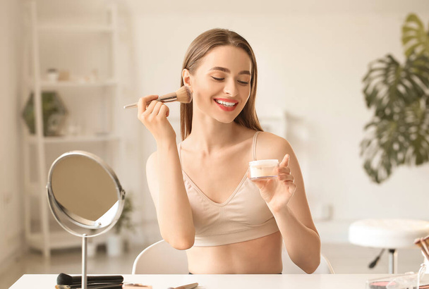 Jeune femme faisant du maquillage à la maison - Photo, image