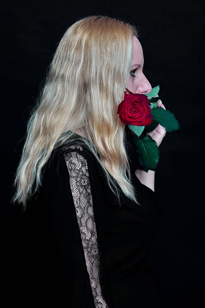Photo session in the studio. White woman with a book and a rose. Cool - Fotoğraf, Görsel