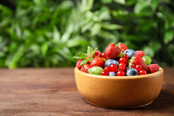 Mix of ripe berries on wooden table. Space for text - Fotoğraf, Görsel