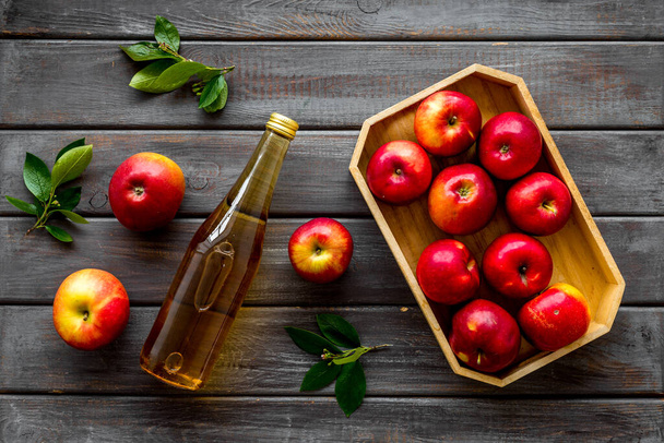 Apple cider vinegar in bottle with fruits top view - Foto, Imagen