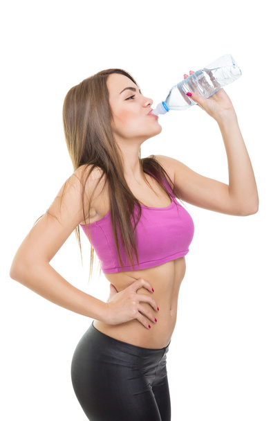 Woman drinking water during exercise - Photo, Image