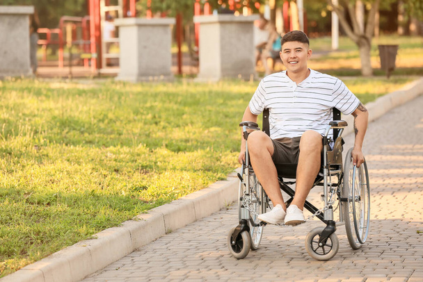 Young man in wheelchair outdoors - 写真・画像