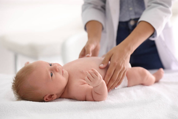 Doctor examining cute baby indoors, closeup. Health care - Фото, изображение