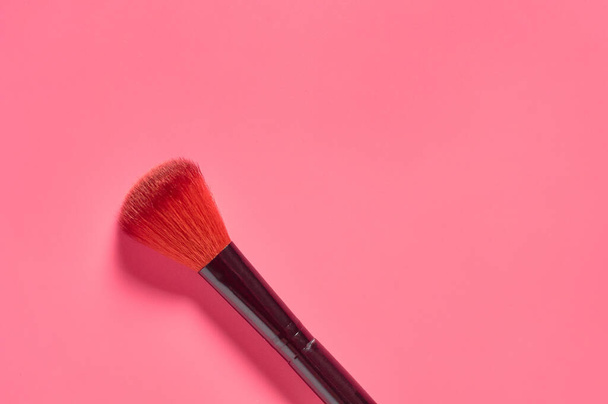 Soft cosmetic brush for blush on pink background. Beauty and fashion concept - Photo, Image