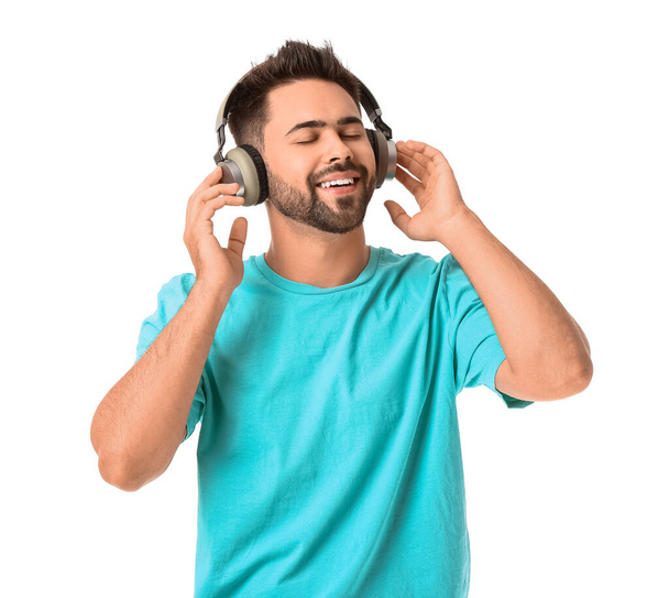 Young man with headphones on white background - Фото, изображение