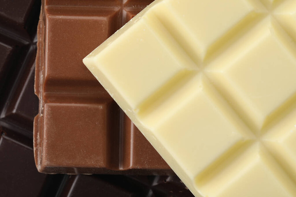Different delicious chocolate as background, closeup view - 写真・画像