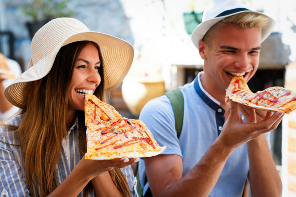 Friends having fun and eating pizza. Dating,consumerism, travel, food and lifestyle concept. - 写真・画像