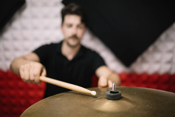 Out of focus man holding sticks and playing cymbals - Фото, изображение
