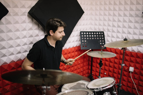 Musician playing drum kit in music studio - Fotoğraf, Görsel