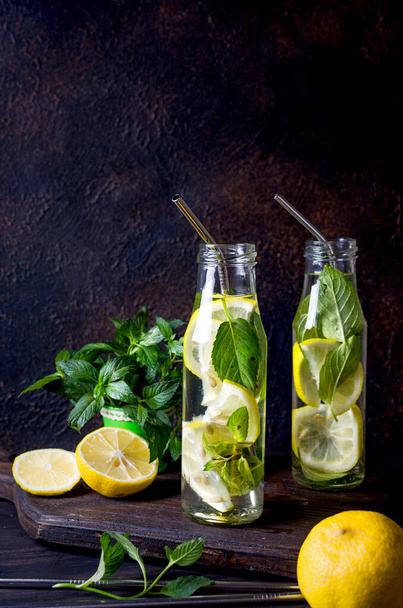 Fresh mojito drinks in bottles and ingredients - lemon and mint - Photo, image
