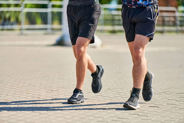 Running men. Sport men jogging in sportswear on city road. Healthy lifestyle, fitness hobby. Street marathon race, sprinting outdoor - Valokuva, kuva