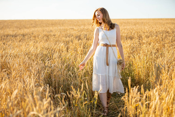 Happy young woman on field in summer day in Czech republic - Photo, image