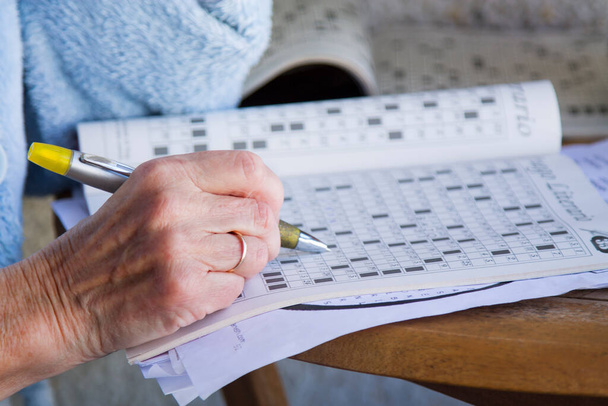 senior woman doing crossword puzzles and hobbies - Photo, image
