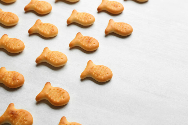Delicious goldfish crackers on white table, closeup - Photo, image