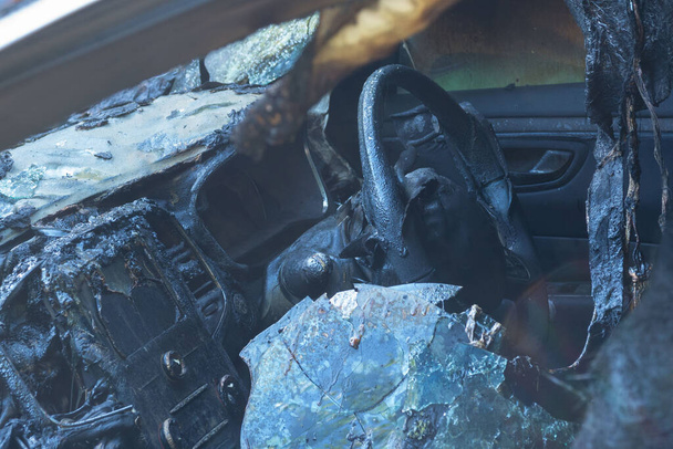 Burnt-out passenger car. Burnt car interior close-up. Fire in the car. Danger. - 写真・画像