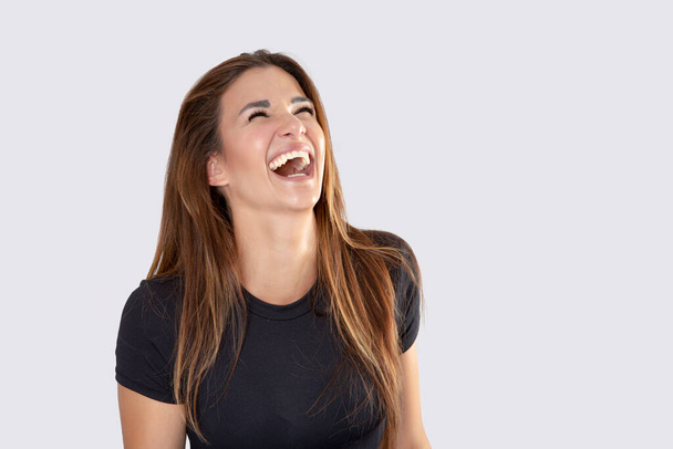 beautiful nice girl laughing with long flowing hair on white background - Fotó, kép