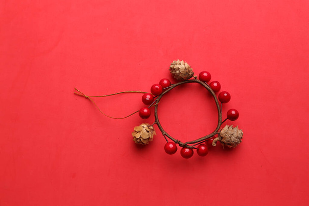 A closeup shot of a decorative wooden trinket isolated on a red background - Photo, Image