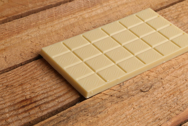 A white chocolate tablet in color background - Foto, Imagen