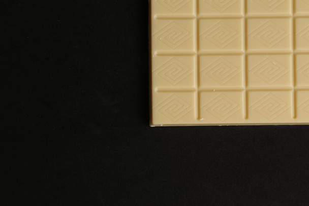 An overhead shot of milk chocolate on the monochrome background - Valokuva, kuva