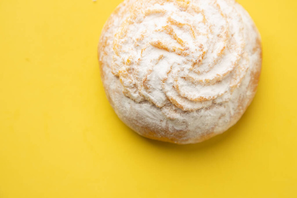 An overhead shot of an appetizing cake isolated on a yellow background - Photo, image