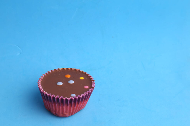 A chocolate cupcake on green background - Photo, Image