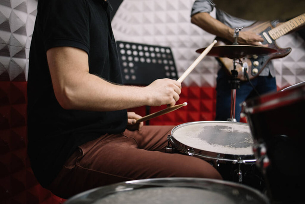 Male hands with drumsticks playing on drum set - Фото, зображення