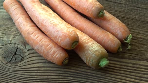 Zanahorias frescas y maduras sobre fondo de madera - Metraje, vídeo